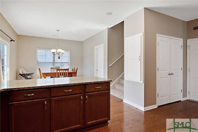 901 Garden Hills Loop, Richmond Hill, GA 31324 - kitchen featuring a chandelier, dark wood-style floors, healthy amount of natural light, and light stone countertops