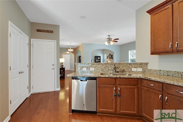 901 Garden Hills Loop, Richmond Hill, GA 31324 - kitchen with dishwasher, a sink, arched walkways, a peninsula, and wood finished floors