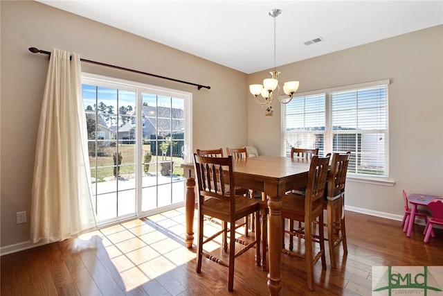 901 Garden Hills Loop, Richmond Hill, GA 31324 - dining room with a chandelier, healthy amount of natural light, and wood finished floors