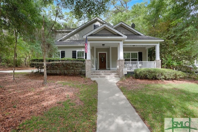 190 Blackjack Oak Dr E, Richmond Hill, GA 31324 - view of front of house featuring covered porch, brick siding, and a front yard