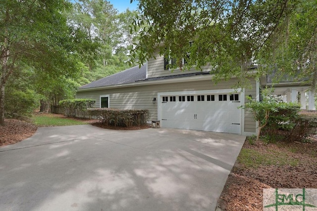 190 Blackjack Oak Dr E, Richmond Hill, GA 31324 - view of side of property with driveway and a garage