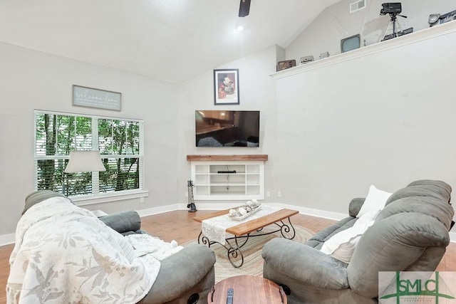 190 Blackjack Oak Dr E, Richmond Hill, GA 31324 - living area with wood finished floors, vaulted ceiling, and baseboards