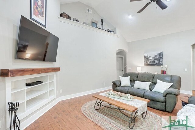 190 Blackjack Oak Dr E, Richmond Hill, GA 31324 - living room with arched walkways, ceiling fan, wood finished floors, baseboards, and high vaulted ceiling