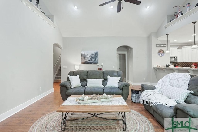 190 Blackjack Oak Dr E, Richmond Hill, GA 31324 - living area featuring arched walkways, a ceiling fan, stairs, wood finished floors, and baseboards