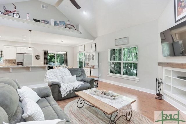 190 Blackjack Oak Dr E, Richmond Hill, GA 31324 - living room with a ceiling fan, high vaulted ceiling, light wood-style flooring, a chandelier, and baseboards