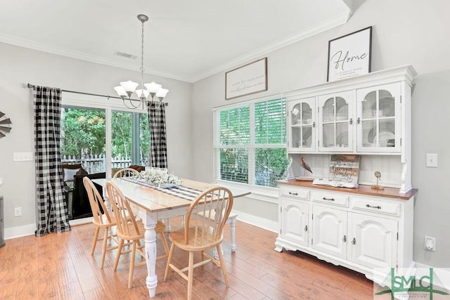 190 Blackjack Oak Dr E, Richmond Hill, GA 31324 - dining space featuring ornamental molding, a chandelier, healthy amount of natural light, and light wood finished floors