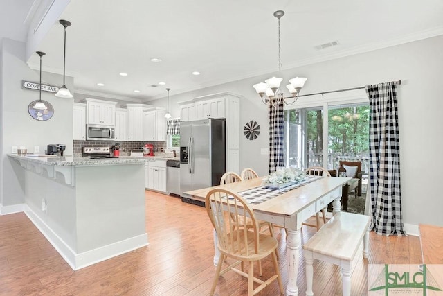 190 Blackjack Oak Dr E, Richmond Hill, GA 31324 - dining area with a chandelier, crown molding, healthy amount of natural light, light wood finished floors, and recessed lighting