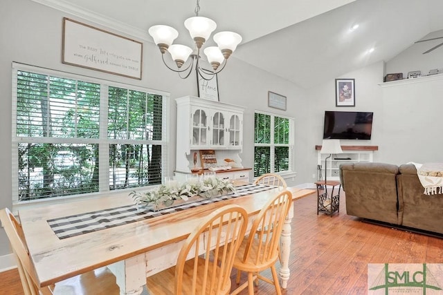 190 Blackjack Oak Dr E, Richmond Hill, GA 31324 - dining area featuring a chandelier, light wood-style flooring, vaulted ceiling, and baseboards