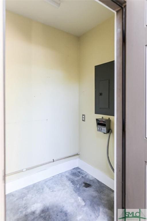 washroom featuring electric panel and baseboards