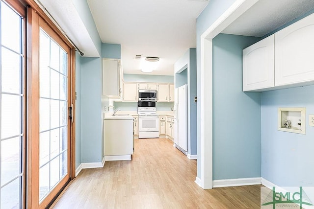 washroom with light wood-style floors and baseboards