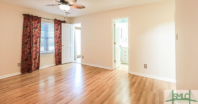 unfurnished room featuring a ceiling fan, light wood-type flooring, and baseboards