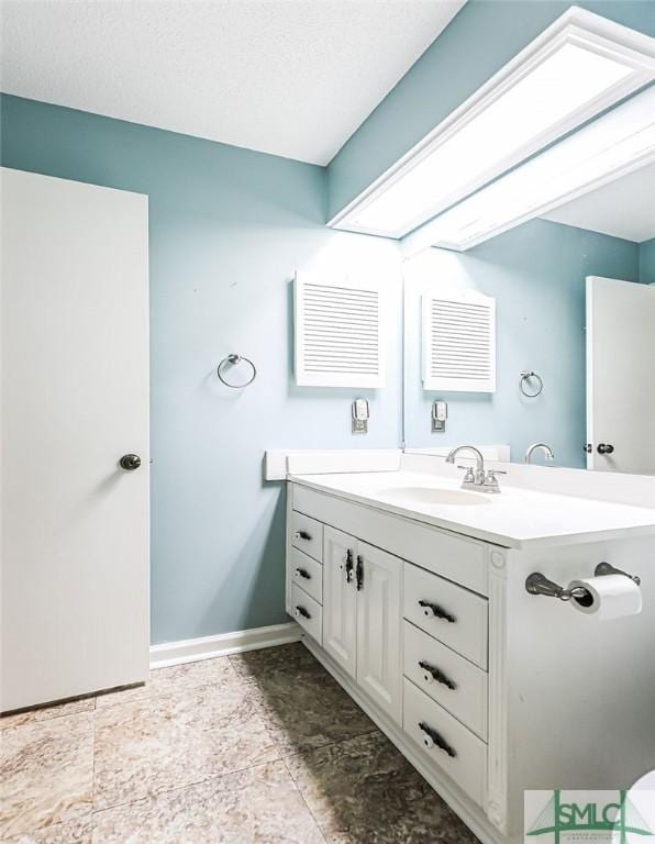 bathroom with vanity and baseboards