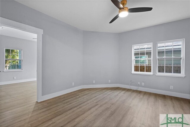 3205 Burroughs St, Savannah, GA 31405 - empty room with wood finished floors, a ceiling fan, and baseboards