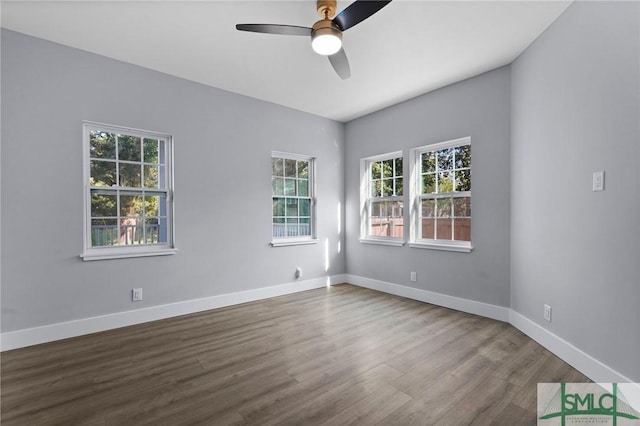 3205 Burroughs St, Savannah, GA 31405 - empty room with dark wood-type flooring, ceiling fan, and baseboards