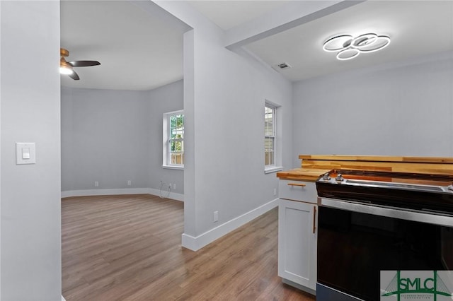 3205 Burroughs St, Savannah, GA 31405 - kitchen featuring black / electric stove, light wood-style floors, baseboards, a ceiling fan, and butcher block counters