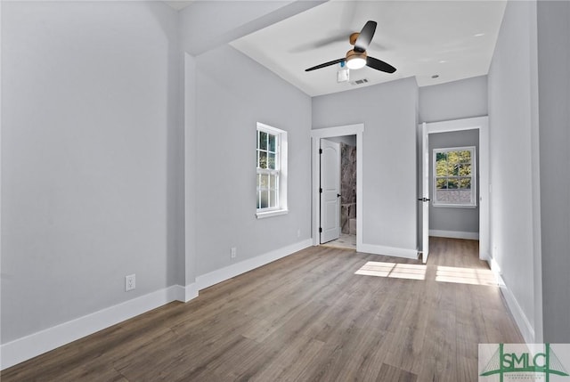 3205 Burroughs St, Savannah, GA 31405 - unfurnished bedroom with baseboards, wood finished floors, and connected bathroom