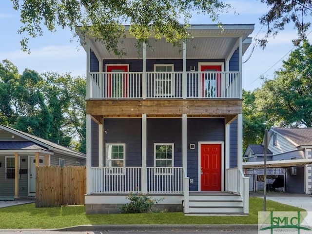 3205 Burroughs St, Savannah, GA 31405 - view of front of property featuring a balcony, a porch, fence, and a carport