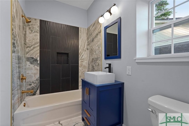 3205 Burroughs St, Savannah, GA 31405 - bathroom with marble look tile flooring, washtub / shower combination, toilet, and vanity