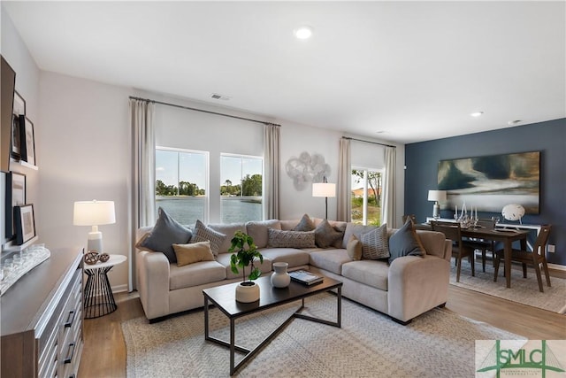 living room featuring wood finished floors, recessed lighting, and baseboards