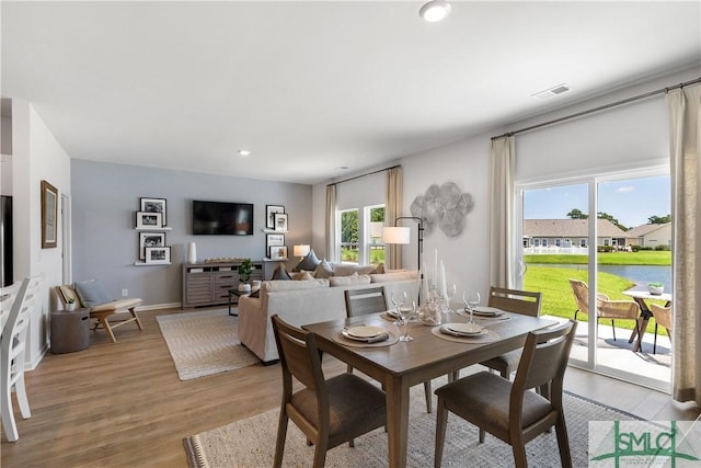 dining space featuring light wood-type flooring and recessed lighting