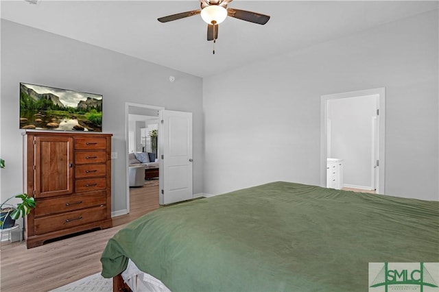 bedroom featuring wood finished floors, ceiling fan, connected bathroom, and baseboards