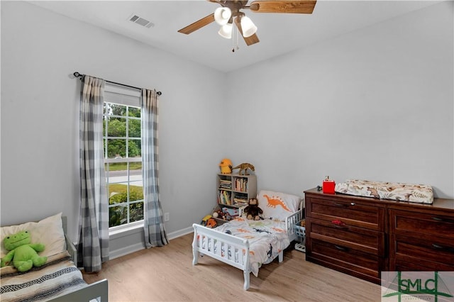 bedroom featuring wood finished floors, baseboards, and ceiling fan