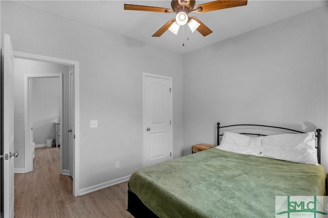 bedroom with wood finished floors, baseboards, and ceiling fan