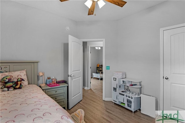 bedroom featuring wood finished floors, baseboards, and ceiling fan