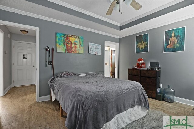 2431 Walden Way, Statesboro, GA 30458 - bedroom with wood finished floors, crown molding, baseboards, and a ceiling fan