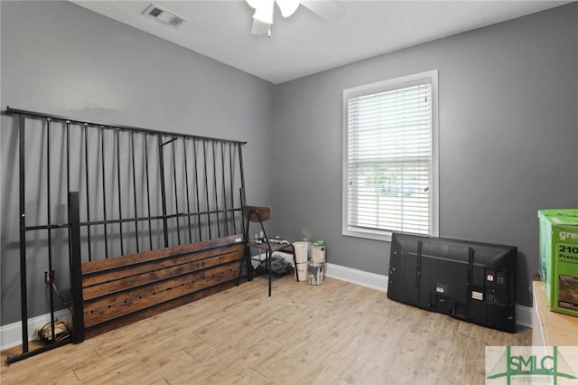 living area with wood finished floors, ceiling fan, baseboards, and plenty of natural light