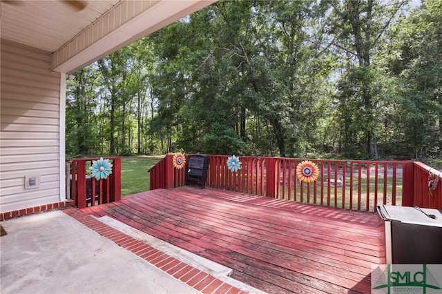 wooden terrace with view of wooded area