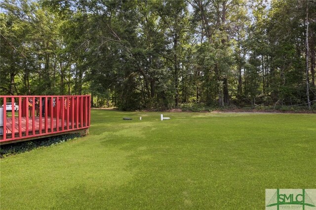 2431 Walden Way, Statesboro, GA 30458 - view of green lawn with a deck and view of scattered trees