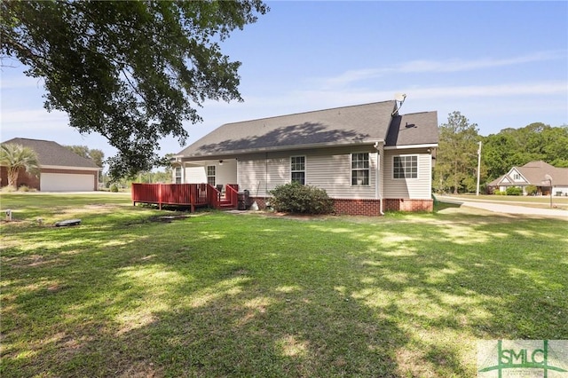 view of front of property with a front yard and a deck