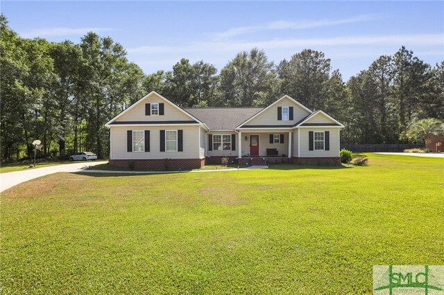 2431 Walden Way, Statesboro, GA 30458 - view of front of house featuring a porch, a front yard, driveway, and view of wooded area
