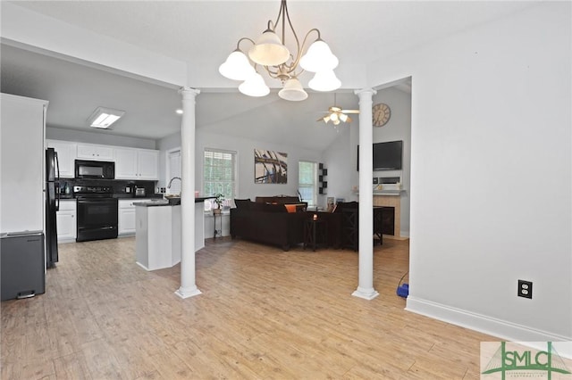 dining area with ornate columns, a ceiling fan, vaulted ceiling, light wood-style floors, and a chandelier