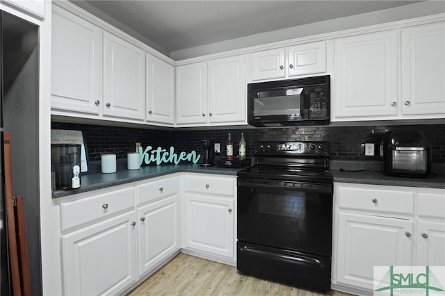 kitchen featuring black appliances, dark countertops, white cabinetry, and tasteful backsplash