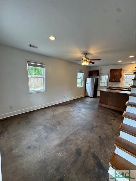 1305 E Anderson St, Savannah, GA 31404 - unfurnished living room with unfinished concrete flooring, baseboards, recessed lighting, and ceiling fan