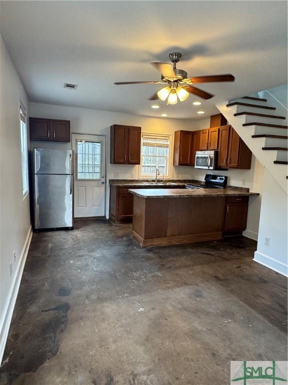 1305 E Anderson St, Savannah, GA 31404 - kitchen featuring appliances with stainless steel finishes, unfinished concrete floors, baseboards, a ceiling fan, and recessed lighting