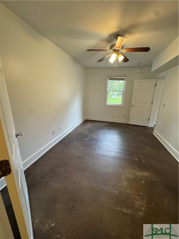 1305 E Anderson St, Savannah, GA 31404 - unfurnished bedroom featuring concrete floors, baseboards, and ceiling fan
