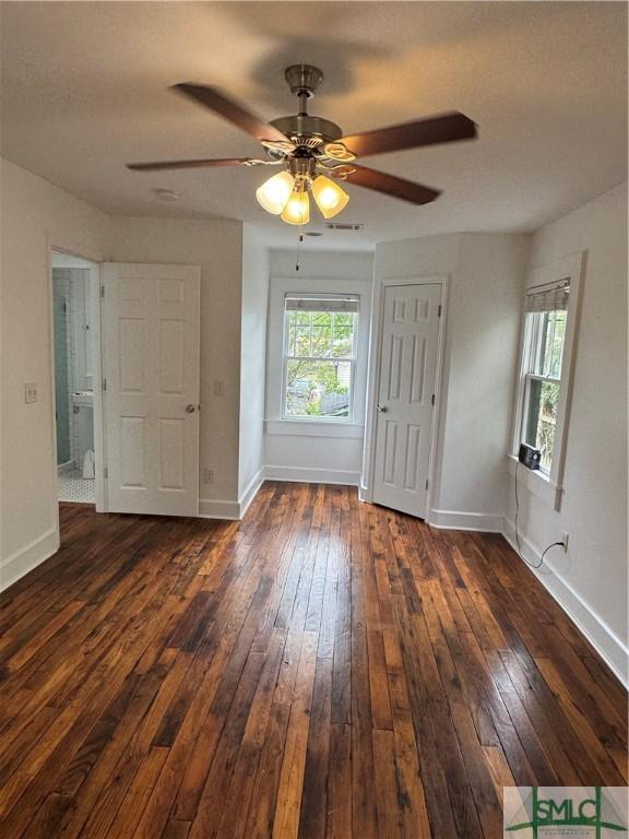 1305 E Anderson St, Savannah, GA 31404 - empty room featuring dark wood-style flooring, baseboards, and ceiling fan
