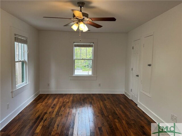 1305 E Anderson St, Savannah, GA 31404 - empty room featuring dark wood-type flooring, baseboards, and a ceiling fan