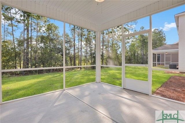 unfurnished sunroom featuring ceiling fan