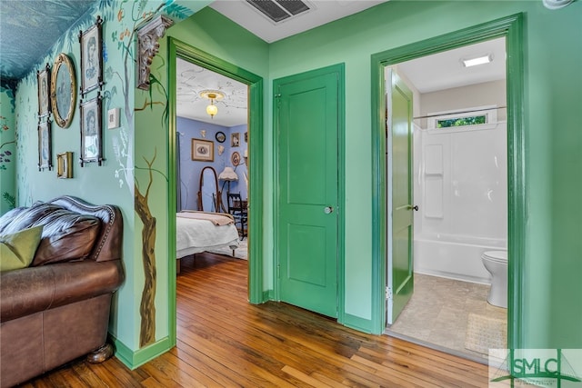 239 Chatham Ave, Pooler, GA 31322 - bedroom with wood finished floors, connected bathroom, and baseboards