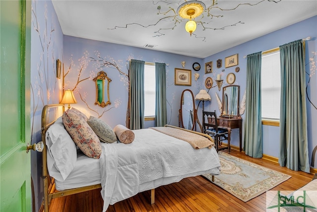 239 Chatham Ave, Pooler, GA 31322 - bedroom featuring multiple windows, wood finished floors, and baseboards