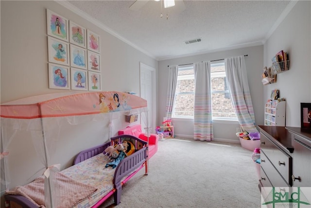 playroom featuring crown molding, carpet, a textured ceiling, baseboards, and a ceiling fan