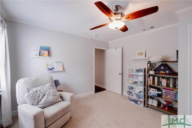 living area featuring a ceiling fan, carpet, crown molding, and baseboards