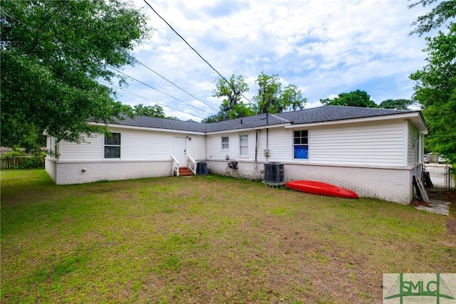 back of house featuring entry steps, central AC unit, and brick siding