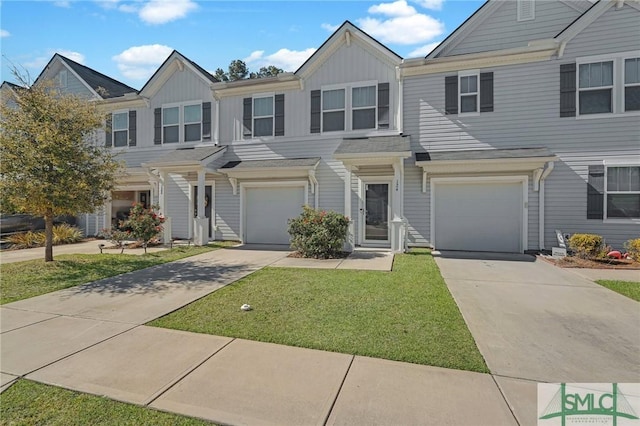124 Benelli Dr, Pooler, GA 31322 - multi unit property with an attached garage, concrete driveway, board and batten siding, and a front lawn