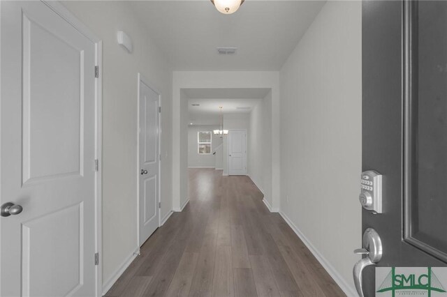 124 Benelli Dr, Pooler, GA 31322 - hall with wood finished floors, baseboards, and a chandelier