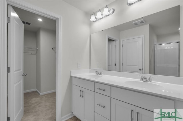 124 Benelli Dr, Pooler, GA 31322 - bathroom featuring baseboards, double vanity, a shower with door, and a spacious closet